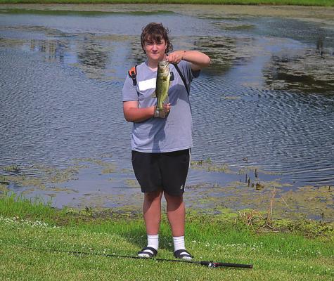 GRIFFIN SMITH shows off the bass he caught this week while fishing at Century Park in Excelsior Springs. Fishing is among the many outdoor activities area residents can enjoy this summer in Excelsior Springs. DUSTIN DANNER | Staff
