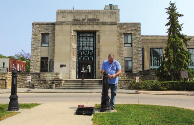 OUTSIDE the Hall of Waters, building superintendent T.R. Kennedy replaces a light. Much more maintenance, perhaps $20 million worth, is still needed. J.C. VENTIMIGLIA | Staff
