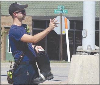 The Excelsior Springs Fire Department recently collected donations to benefit the Muscular Dystrophy Association at the intersection of Crown Hill Road and Kearny Road. Kelsey Cohalla (above) waves to cars as they pass by the intersection while Kevin Guck (below) waits for traffic to approach a stop light. ELIZABETH BARNT | Staff