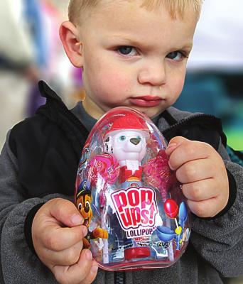 DO NOT TOUCH. Layton Farris, 2, is protective of his Pop Ups, a container of lollipops he claims as a prize after the hunt.
