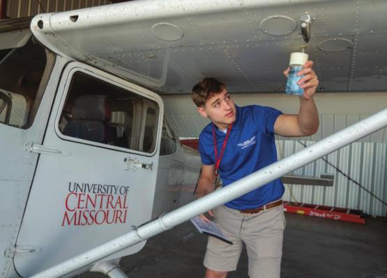 A HIGH SCHOOL STUDENT in the Air Force Junior ROTC Flight Academy at the University of Central Missouri, Bruce Reinhard, conducts a preflight inspection of a Cessna training airplane in preparation to earn his private pilot’s certification.