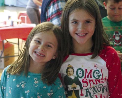 JAYLA (LEFT) AND Jenna Meyer happily wait their turn to paint at a craft booth while visiting the Elf Factory. MIRANDA JAMISON | Staff