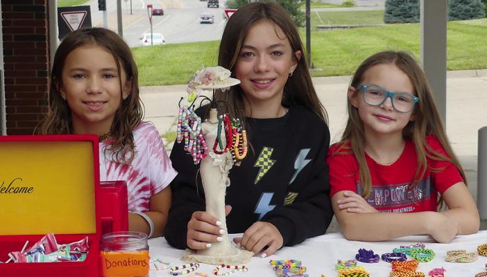 KINSLEY (FROM LEFT), Santina and Bailey Brown offer earrings and hairclips at their booth. See more photos on page 11. ELIZABETH BARNT | Staff
