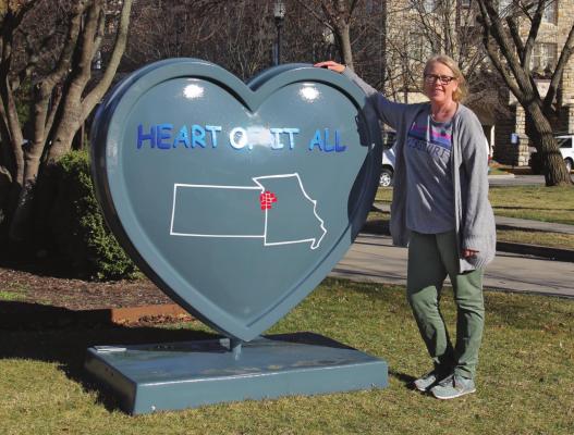 IN FRONT of The Elms Hotel and Spa, Excelsior Springs resident Cynthia Loflin says she likes having the city participate in the metrowide Parade of Hearts. J.C. VENTIMIGLIA | Staff