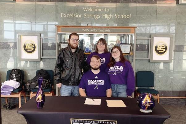 JOSHUA OLDHAM, seated with his brother Jackson, mother Sarah and sister Charlotte standing behind him, enjoys the moment of signing his letter of intent to continue his education and bowling career at Avila University. DUSTIN DANNER | Staff