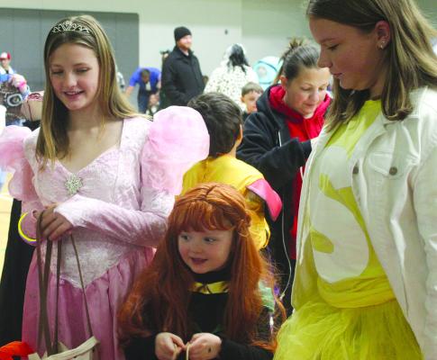 BELLA MANSELL (from left), Scarlett Mansell and Layla Sisson made their way around the Excelsior Springs Community Center in search of goodies. MIRANDA JAMISON | Staff