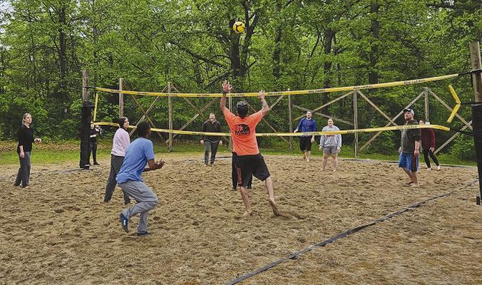 THE EXCELSIOR SPRINGS Elks Lodge sand volleyball league shows their competitive side as they play through the rain. MIRANDA JAMISON | Staff