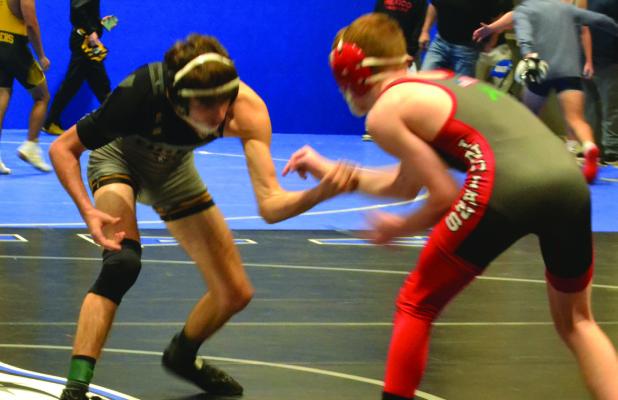 MICAH DANNER (left) works for position during his semifinal match Dec. 2 at the Grain Valley Invitational. DUSTIN DANNER | Staff