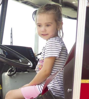 SAWYER VEACA sits inside the firetruck and pretends to drive. See story and photos on page 7. ELIZABETH BARNT | Staff