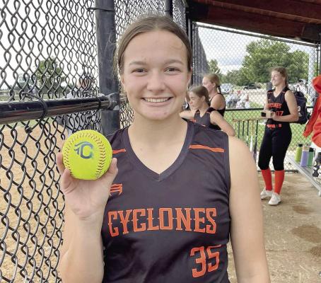 JOSIE CASLER displays a home run ball hit for the Cyclones during the Heartland World Series. DUSTIN DANNER | Staff