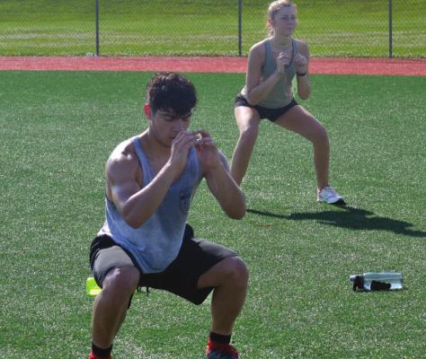 RUDY DeLEON and Tristan Sykes work on full-body squats.