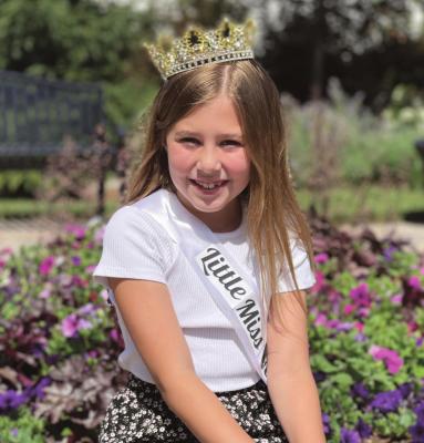 NORAH CRAVEN, 9, wears a new tiara as reigning Little Miss Waterfest. She has held the title for three years straight because of the festival’s cancellations in 2020 and 2021. BRIAN RICE | Staff