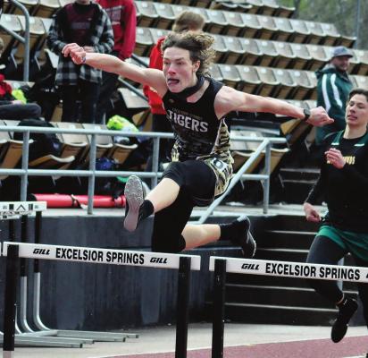GAVIN WILMES is a high-flying Tiger as he goes airborne during the boys 300-meter intermediate hurdles April 23 in the Mineral Water Classic on a cool, rainy day for high school track and field at Excelsior Springs High School. SHAWN RONEY | Staff
