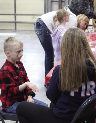 MIRANDA JAMISON | Staff WOOD HEIGHTS Fire Department provides temporary tattoos to participants of their Easter event.