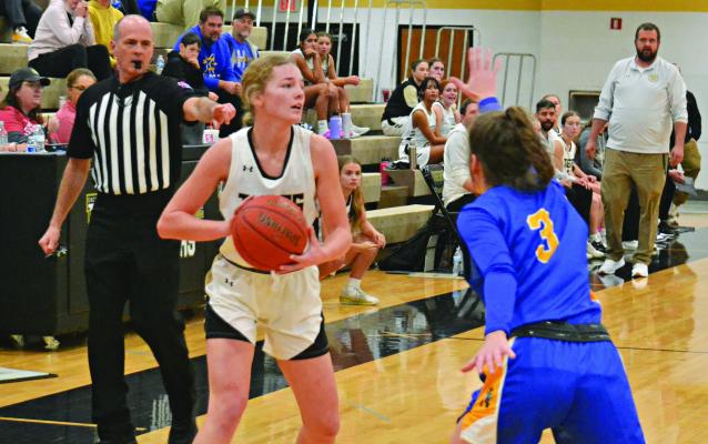 GUARDED BY Lafayette County of Higginsville’s Hailey Linebach (No. 3), Bella Loeffert keeps both hands on the ball as she looks inside for an open teammate Nov. 20 at Excelsior Springs. DUSTIN DANNER | Staff