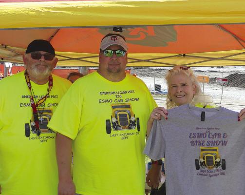 ELIZABETH BARNT | Staff LARRY KERR (from left), Brock Stout and Brenda Spicer show off the annual car show t-shirt representing the car show sponsors.
