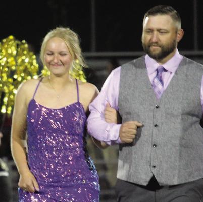 EXCELSIOR SPRINGS High School Senior Homecoming Queen Chloe Carlyle (left) walks with her escort, Clay Carlyle prior to being crowned. More photos on page 6, 7 and 8. MIRANDA JAMISON | Staff