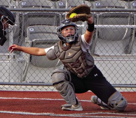 EXCELSIOR SPRINGS senior Chloe Carlyle uses her catcher’s mitt to snag a high one and prevent a wild pitch. DUSTIN DANNER | Staff