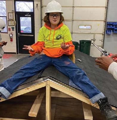 TOGETHER with certifications and a job tip from Excelsior Springs Job Corps, Lauren Randolph, 19, is working on the new terminal roof at KCI. While at Job Corps and at work on this roof model, Randolph says she felt inspired to become a roofer.