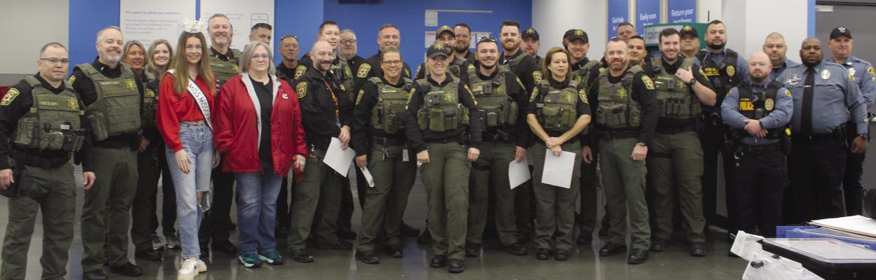 MEMBERS OF THE Clay County Sheriff’s Department and Claycomo Police Department, along with America’s Ideal Miss Missouri, gathered at the Walmart for “Shop with a Sheriff” in Kansas City. MIRANDA JAMISON | Staff