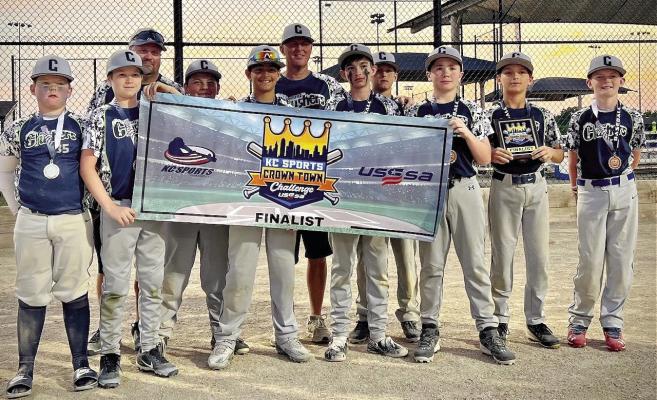 THE CRUSHERS, a 12-and-under Excelsior Springs-based ballclub, display their second-place banner from the KC Sports Crown Town Challenge. Players (from left) are Bently Cramer, Jaxton Smith, Tristan Schmidt, Jack Gray, Braydon Pearson, Kolt Nielsen, Bennett Hughes, Halden Aldana and Connor Marsh. The coaches are J.P. Nielsen and Richie Marsh. DUSTIN DANNER | Staff