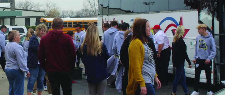STAFF AND STUDENTS of Excelsior Springs High School, along with community members bid farewell to the soccer team as they board the bus, to be escorted by the Excelsior Springs Police Department.
