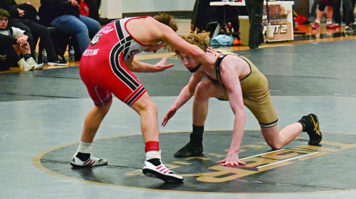 COOPER COLLINS, an Excelsior Springs sophomore (right), looks to take a shot in his 120-pound title match with Odessa’s Blaine Wallace in Class 2 District 4 competition Feb. 17 at Excelsior Springs. DUSTIN DANNER | Staff