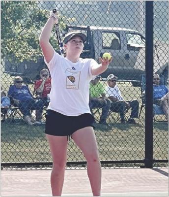 WITH A CROWD behind her, Excelsior Springs first-year high schooler Lainey Smith focuses on her serving during a recent home varsity girls tennis dual. DUSTIN DANNER | Staff