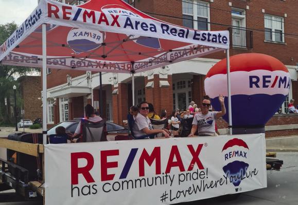 Re/Max Area Real Estate takes first place in the line up of floats. MIRANDA JAMISON | Staff
