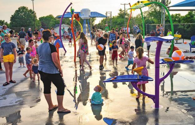ON OPENING DAY, scores of people turn out to take advantage of the water features available at the Rainbow Splash Park, the newest addition to community facilities overseen by the Parks and Recreation Department. The splash park is next to the community center.