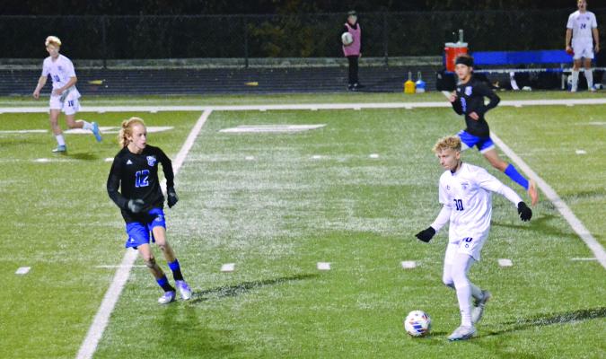 JUNIOR AUSTIN COLLINS (No. 30) controls the possession for Excelsior Springs as Harrisonville defender Seth Estes (No. 12) keeps an eye on the soccer ball during Class 2 state quarterfinal action Nov. 11 at Harrisonville. DUSTIN DANNER | Staff