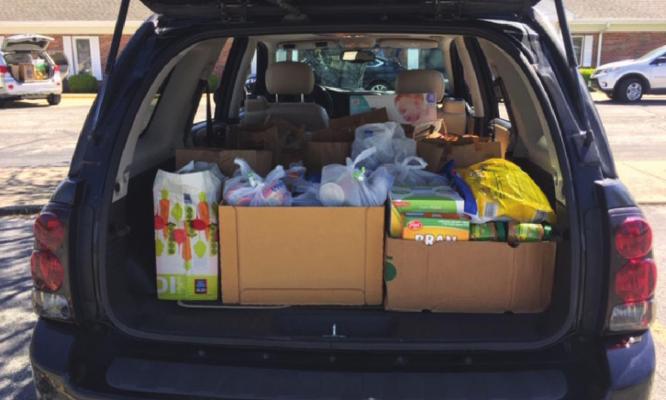 COMMUNITY MEMBERS collect groceries for the Good Samaritan Center.