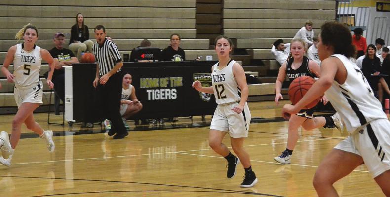 BAYLEE O’DELL, No. 5; Bailey Carder, No. 12; and Ashlon McIntosh look to capitalize on a numbers advantage while running a fast break last week during the Tigers’ 52-49 nail-biting victory over visiting Pleasant Hill. DUSTIN DANNER | Staff