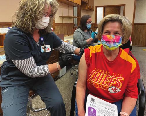 EXCELSIOR SPRINGS Transportation Director Patsy Bradon receives the first shot of the day at Excelsior Springs Hospital’s COVID vaccination site. COURTNEY COLE | Special to the News Standard
