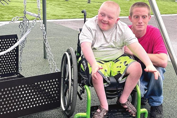 BENTLY FORD, 10, with father Travis, shows his excitement at Cornerstone’s new playground equipment. BRIAN RICE | Staff