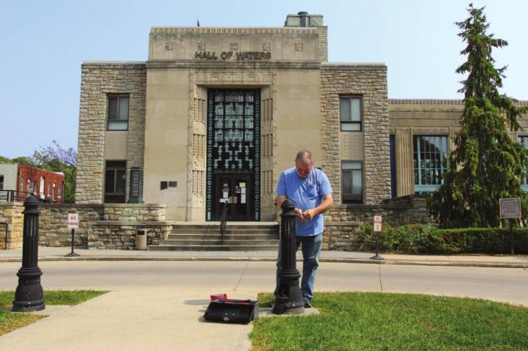 OUTSIDE the Hall of Waters, building superintendent T.R. Kennedy replaces a light. Much more maintenance, perhaps $20 million worth, is still needed. J.C. VENTIMIGLIA | Staff