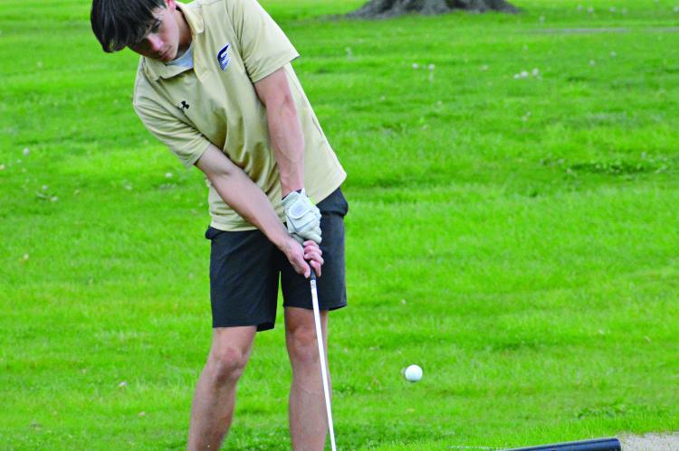EXCELSIOR SPRINGS junior Gage Simmons attempts a chip shot during the Richmond Invitational April 28 at Shirkey Golf Course. SHAWN RONEY | Staff