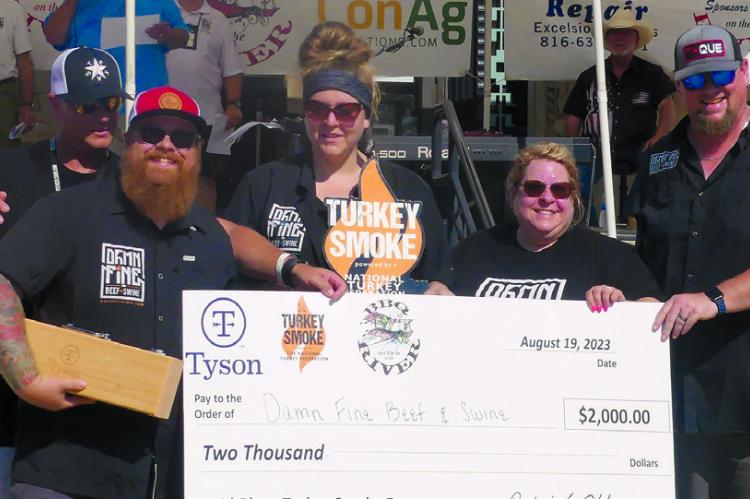 DAMN FINE BEEF AND SWINE win the turkey smoke competition and are awarded the $2,000 grand prize at Fly-In on the River. ELIZABETH BARNT | Staff