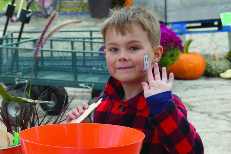 MAVERICK KORB shows off his face painting after receiving a ghostly friend on his cheek. ELIZABETH BARNT | Staff