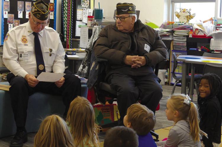 RONALD WETZEL (left) and Micheal Sutko read a letter of thanks after receiving Veterans Day gifts from Cornerstone kindergarten students. ELIZABETH BARNT | Staff