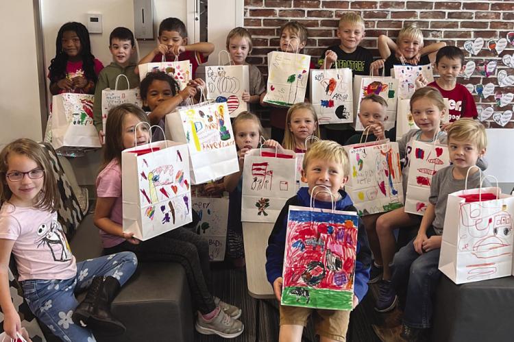 CORNERSTONE ELEMENTARY kindergartners hold decorated gift bags for the visiting veterans. LINDA HASKELL | Submitted