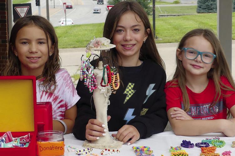 KINSLEY (FROM LEFT), Santina and Bailey Brown offer earrings and hairclips at their booth. See more photos on page 11. ELIZABETH BARNT | Staff