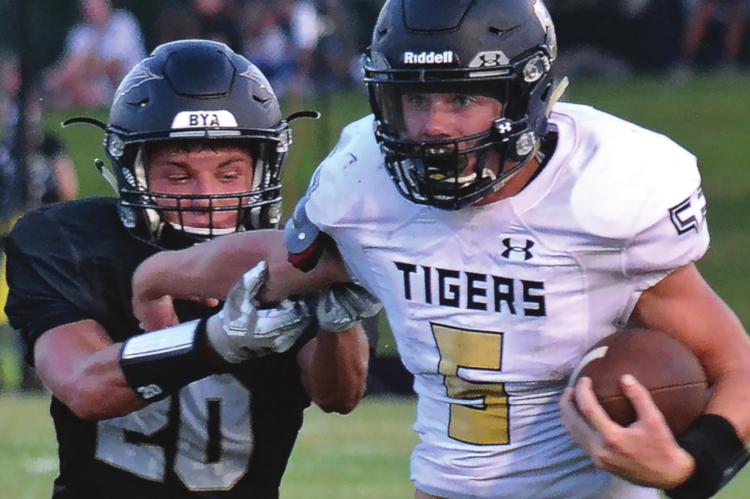 DESPITE INTENSE pursuit by Savannah defensive back Heisman Lafave, Tigers running back Lukas Shelton runs hard down the sideline during Excelsior Springs’ 33-21 Aug. 28 season-opening road win. DUSTIN DANNER | Staff