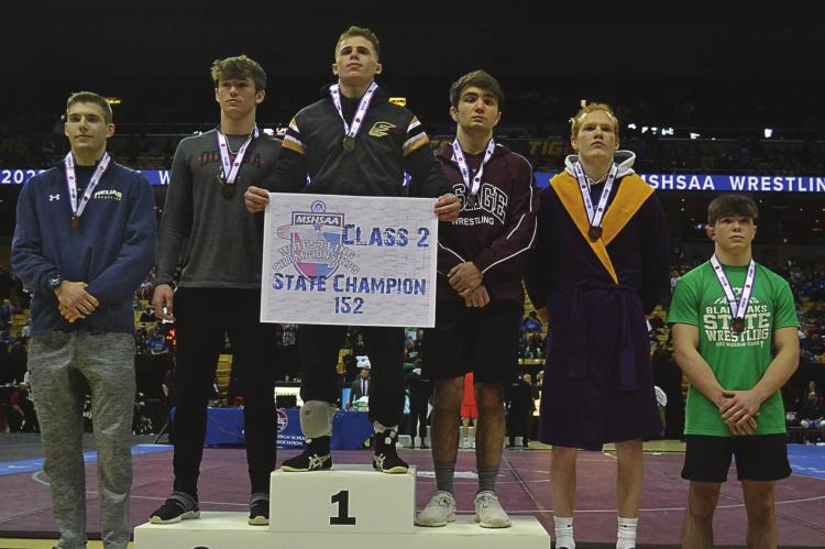 EXCELSIOR SPRINGS senior Ayden Dolt stands atop the competition Feb. 19 in Columbia after winning the Class 2 state boys wrestling title in the 152-pound division. DUSTIN DANNER | Staff