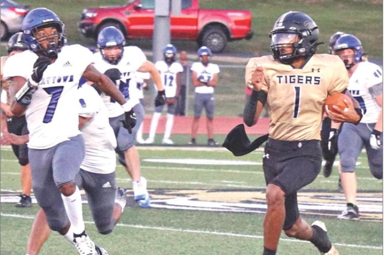 EXCELSIOR SPRINGS QUARTERBACK Marquez McCant (right) races down the sideline for a big gain against Raytown Aug. 31 at Tiger Stadium. TIM HARLAN | Staff