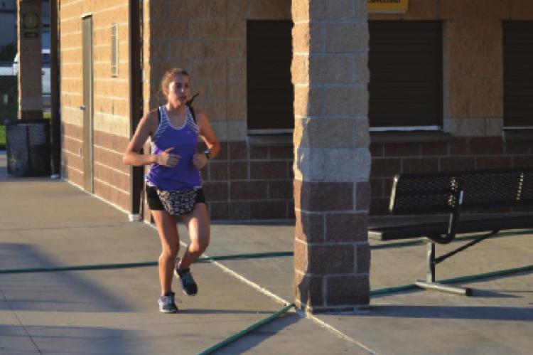 JACEY BREWER gets in a run on the Excelsior Springs High School campus. DUSTIN DANNER | Staff