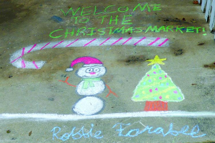 ROBBIE FARABEE kicks off the Winter Market with custom made chalk art for patrons to enjoy. ELIZABETH BARNT | Staff