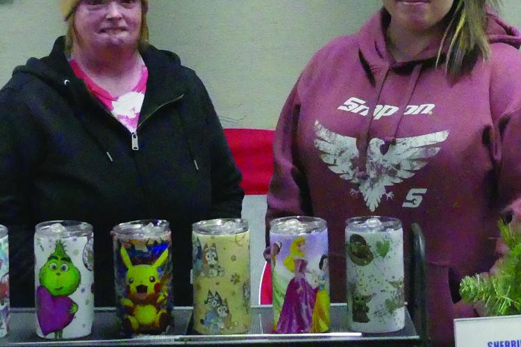 SHERRIE FOSTER (left) and Shelby Reiff showcase their hand crafted cups at the Winter Market.