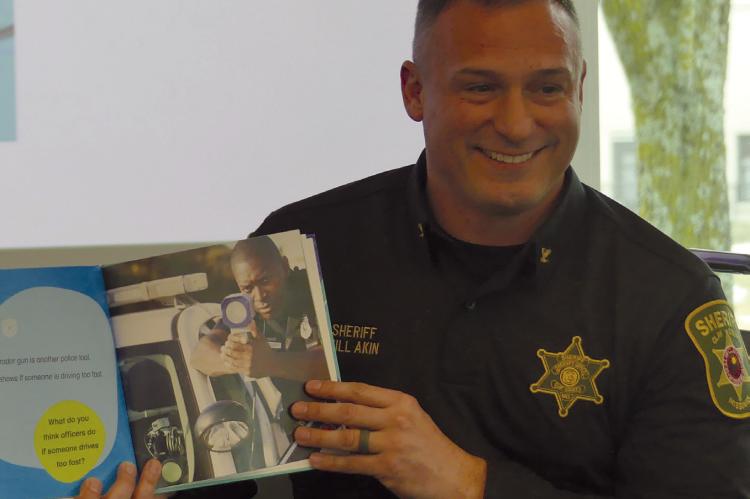CLAY COUNTY SHERIFF Will Akin joyfully shares his passion for law enforcement while reading police centered children’s books during Hero Story Time at Mid-Continent Public Library Excelsior Springs Branch. ELIZABETH BARNT | Staff