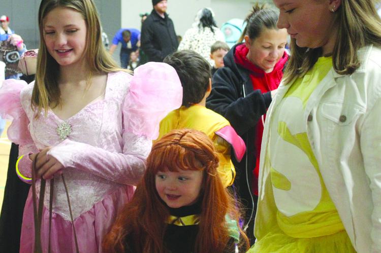 BELLA MANSELL (from left), Scarlett Mansell and Layla Sisson made their way around the Excelsior Springs Community Center in search of goodies. MIRANDA JAMISON | Staff